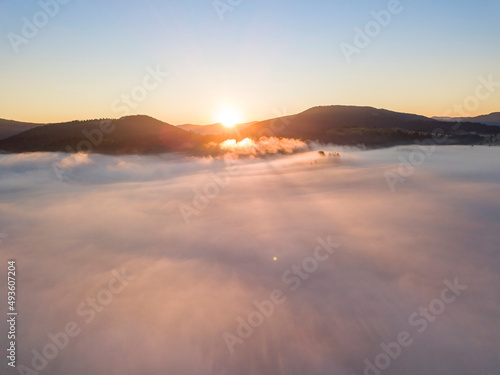 Sunrise over the fog in the Ukrainian Carpathians. Aerial drone view.