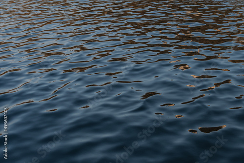 Water. Small ripples in the water of the Rio Po in Italy. Background, texture of dark blue color. photo