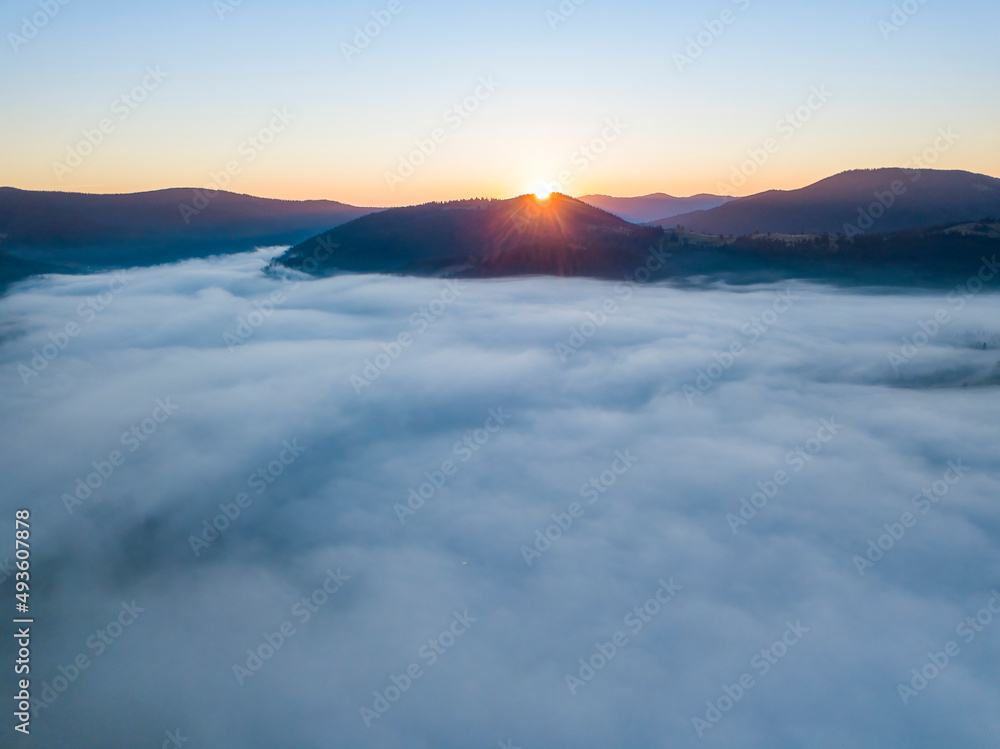 Sunrise over the fog in the Ukrainian Carpathians. Aerial drone view. Sunrise over the fog in the Ukrainian Carpathians. Aerial drone view.