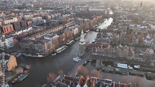 Montelbaanstoren Amsterdam urban canals Aerial city view at golden hour sunset. Historic city center. Facades touristic landmarks. Old tower church. photo