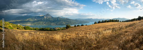 Serre-Poncon lake in Summer with approaching storm. Panoramic view of the villages of Saint-Apollinaire and Savines-le-Lac. Durance Valley in Hautes-Alpes (Alps). France