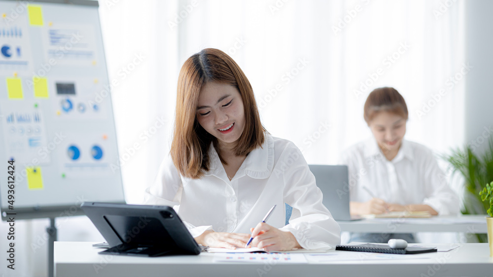 Atmosphere in the office of a start-up company, a female employee sits in the office, she is sitting in the sales department where she is making monthly sales summary to make a report to the manager. Atmosphere in the office of a start-up company, a female employee sits in the office, she is sitting in the sales department where she is making monthly sales summary to make a report to the manager.
