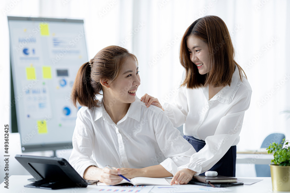 Atmosphere in the office of a startup company, two female employees are discussing, brainstorming ideas to working on summaries and marketing plans to increase sales and prepare reports to managers. Atmosphere in the office of a startup company, two female employees are discussing, brainstorming ideas to working on summaries and marketing plans to increase sales and prepare reports to managers.
