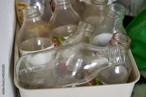 Obraz na płótnie dirty, old, empty bottles in garbage segregation w salonie