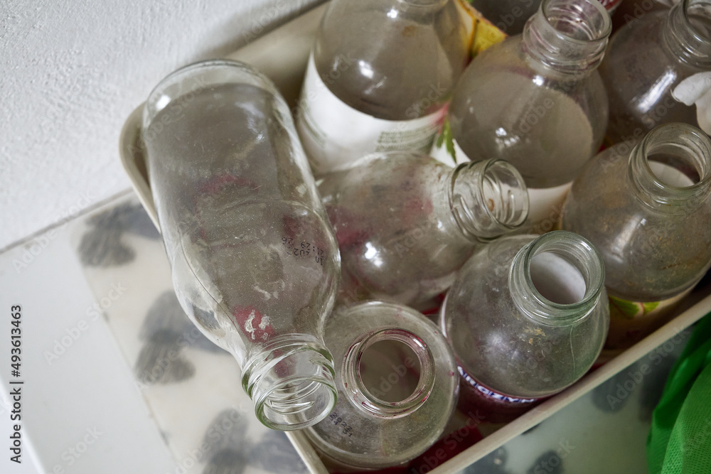 dirty, old, empty bottles in garbage segregation