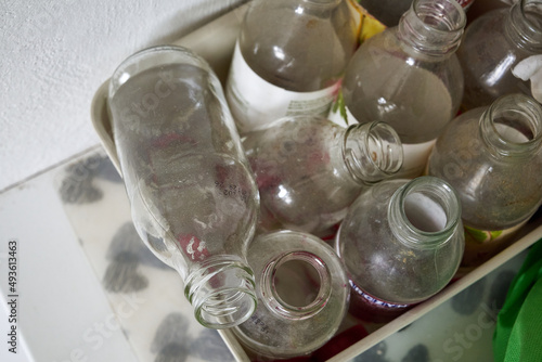 Obraz na płótnie dirty, old, empty bottles in garbage segregation w salonie