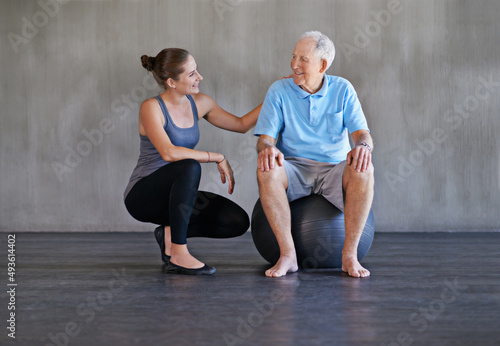 Helping my patients recover is my only priority. Shot of a a physical therapist working with a senior man.