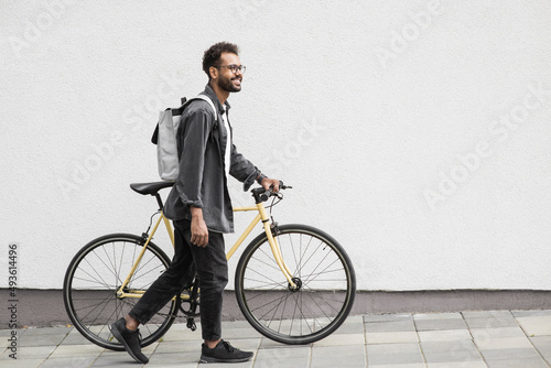 Handsome young man with bicycle in city, Smiling student men outdoor portrait, Active lifestyle, people, city life, having fun, casual business concept