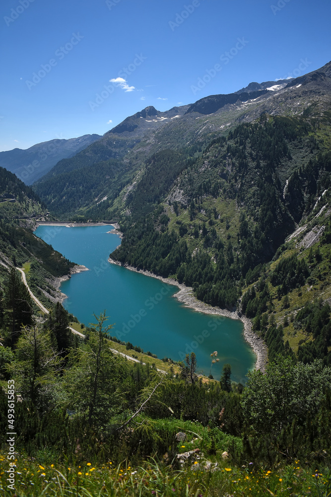 Great view on the Galgenbichlspeicher, a dam in the alps with beautiful blue water and high mountains. Landscape in Kärnten, Austria.