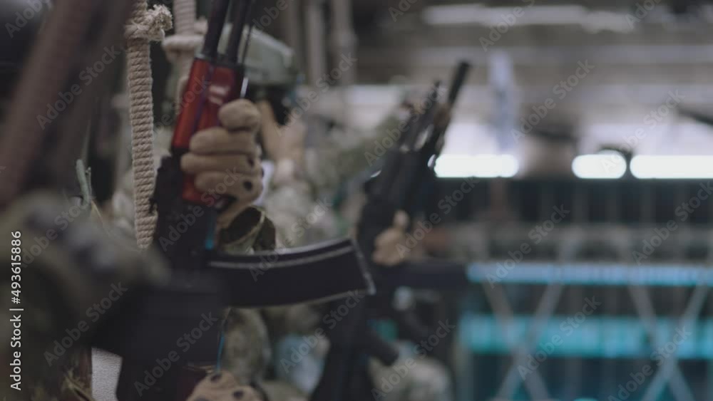 Group of Soldiers or Special Forces Loading weapons and installing Magazine Before Fight . Military , war or strike ball theme concept . Shot on ARRI Alexa cinema camera in Slow Motion . Close up view Group of Soldiers or Special Forces Loading weapons and installing Magazine Before Fight . Military , war or strike ball theme concept . Shot on ARRI Alexa cinema camera in Slow Motion . Close up view