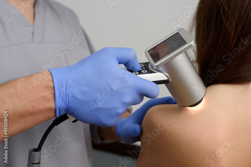 Digital dermatoscopy of moles. A dermatologist-oncologist examines the patient's moles using a dermatoscope. Prevention and early diagnosis of skin melanoma. Dermatological clinic. Close-up shot. photo