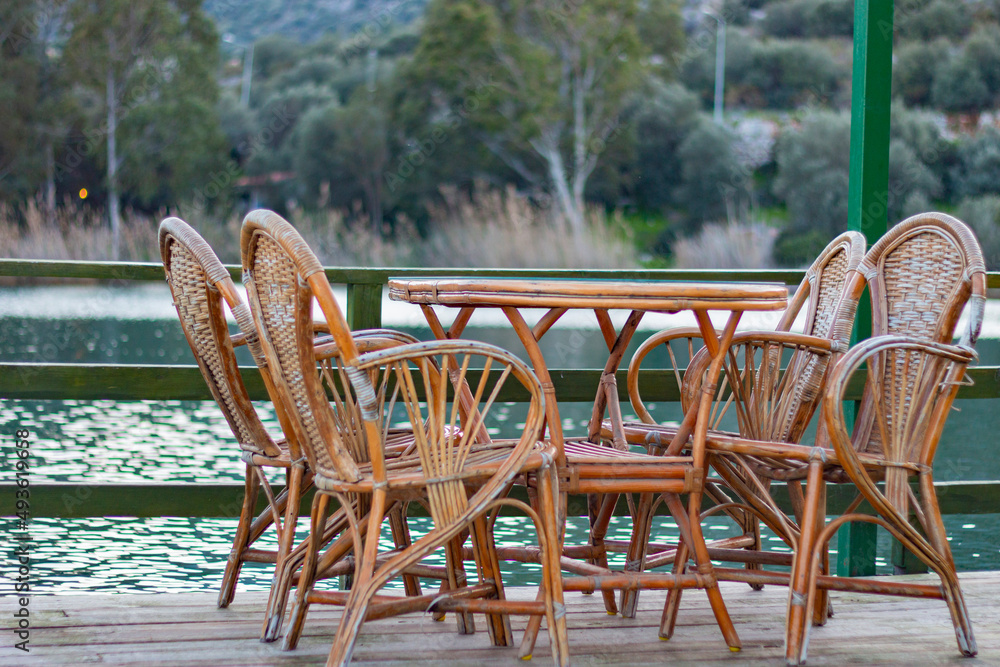 Empty table with river and trees view. Wooden garden furniture. Peaceful, nice and quiet veranda. Empty table with river and trees view. Wooden garden furniture. Peaceful, nice and quiet veranda.