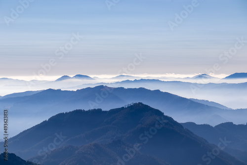 A panoramic view on the mountain peaks of the Hochschwab Region in Upper Styria, Austria. Cloudless weather on a sunny summer day in the Alps. Blue misty valley and soft hills. Concept freedom © Chris