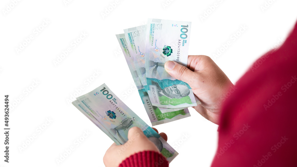 latin man counting colombian money , red sack, businessman or entrepreneur on white background latin man counting colombian money , red sack, businessman or entrepreneur on white background