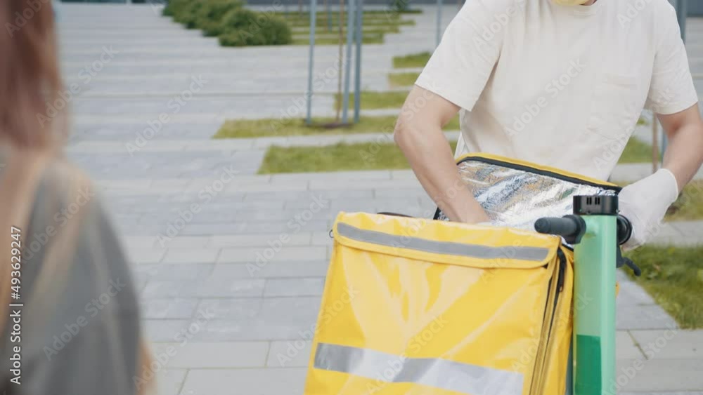 An young mailman courier with a protective mask and gloves is
