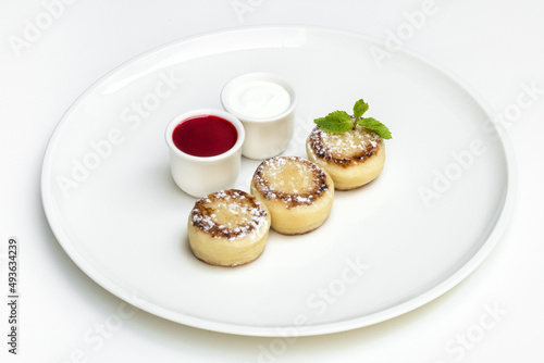 Pancakes with jam and cottage cheese, sweetness. Photograph of food on a light background