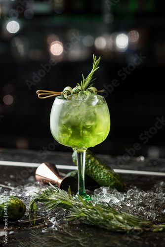 Alcoholic green drink in a glass, cocktail. Photography of drinks on a dark background