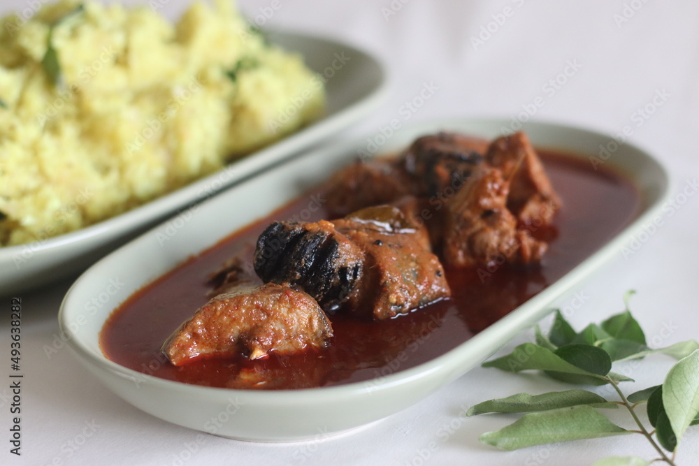 Mackerel curry prepared in central Kerala style with red chilies and Malabar tamarind. Served with Mashed dry casava or dry tapioca