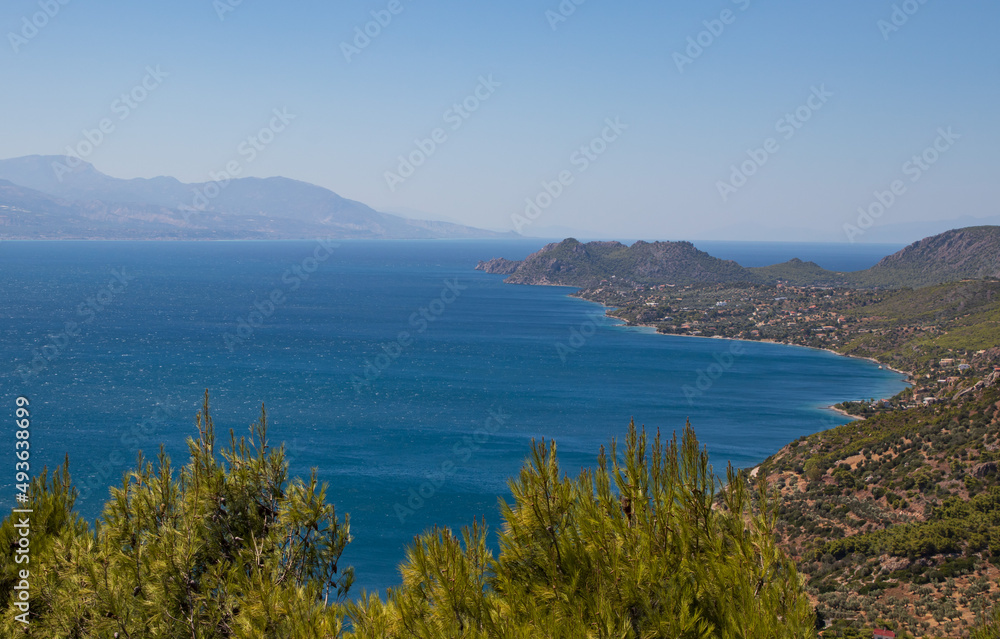 Beautiful seascape, coastline with blue Mediterranean Sea and green trees from top view, Greece