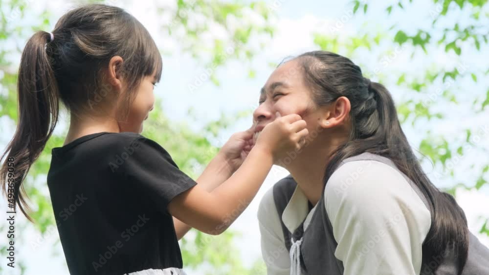 Happy mother playing with her daughter in the park. The family spends time together on vacation. Happy mother playing with her daughter in the park. The family spends time together on vacation.