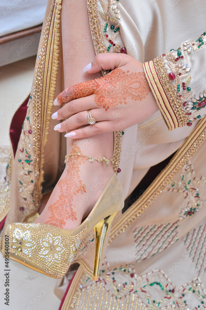 Female legs and hands with henna tattoo. moroccan bride's showing mehndi design. mehndi hands and feet. beautiful female hands with mehndi tattoos. moroccan tradition..