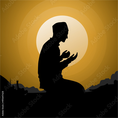 Silhouette of muslim man praying