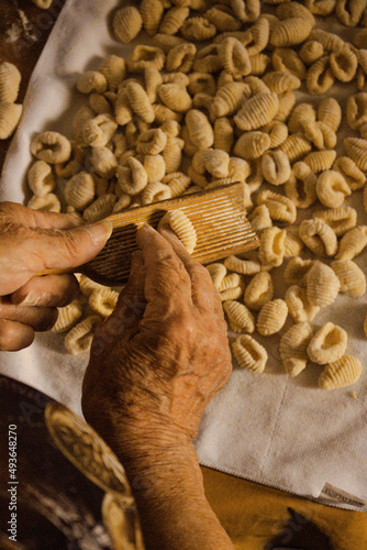 grandmother kneading hands kneading gnocchi
