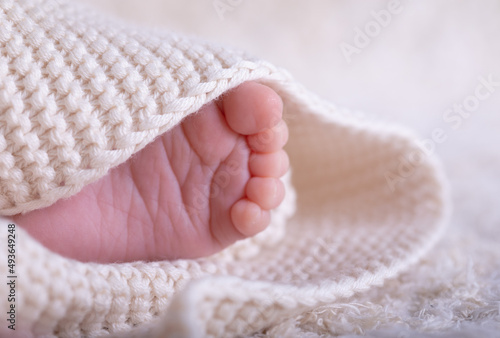 New Born Baby Feet on White Blanket