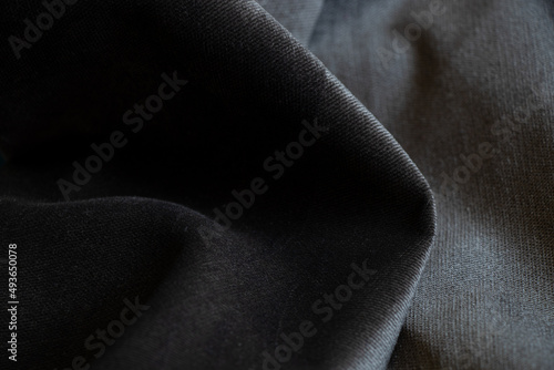 Gray black wrinkled velor fabric as background closeup, fashion and trends, gray
