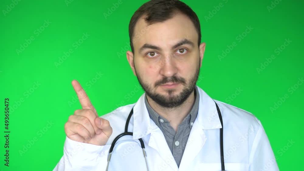 Medical doctor man looking at camera and waving finger to reject. Green screen background Medical doctor man looking at camera and waving finger to reject. Green screen background