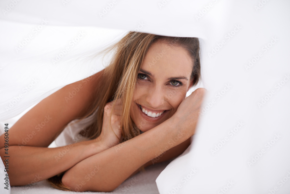 Fototapeta premium I think Im just going to stay right here.... Portrait of a beautiful young woman enjoying a morning in bed.