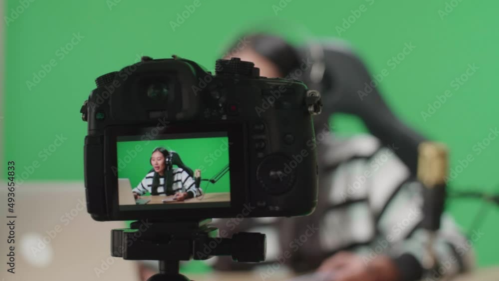 Close Up Of A Camera Monitor Recording Asian Woman Gamer With Headphone Reading Comment On Computer While Playing Game On Mobile Phone On Green Screen
Close Up Of A Camera Monitor Recording Asian Woman Gamer With Headphone Reading Comment On Computer While Playing Game On Mobile Phone On Green Screen