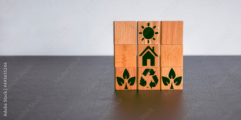 wooden cube with the icon of the sun, home, ecology wooden cube with the icon of the sun, home, ecology