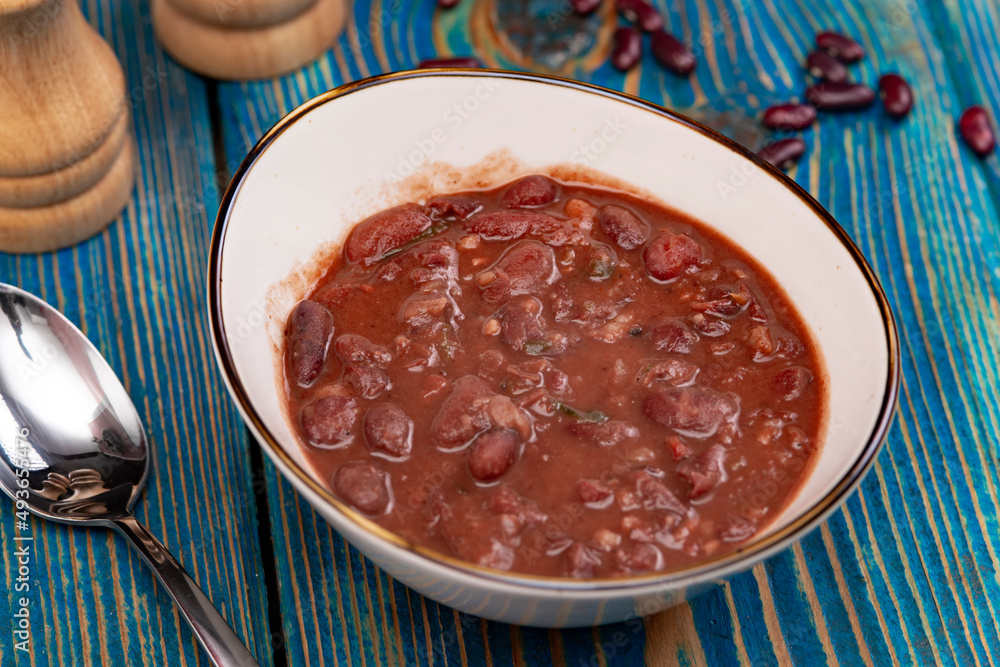 Healthy bean soup with red beans, Homemade Soup on blue wooden background , Vegetarian Food. Healthy bean soup with red beans, Homemade Soup on blue wooden background , Vegetarian Food.