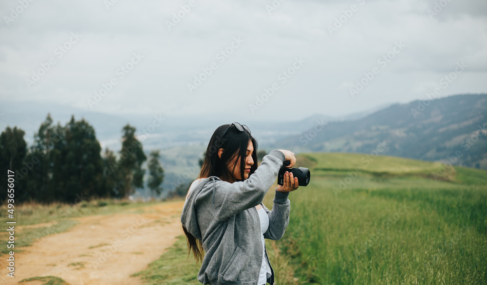 Joven fotógrafa mujer en una montaña. Concepto de Personas y Tecnología, Turismo.