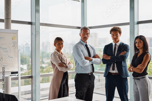 Are you ready to join the white collar workforce. Cropped shot of corporate businesspeople standing with their arms crossed in the office.