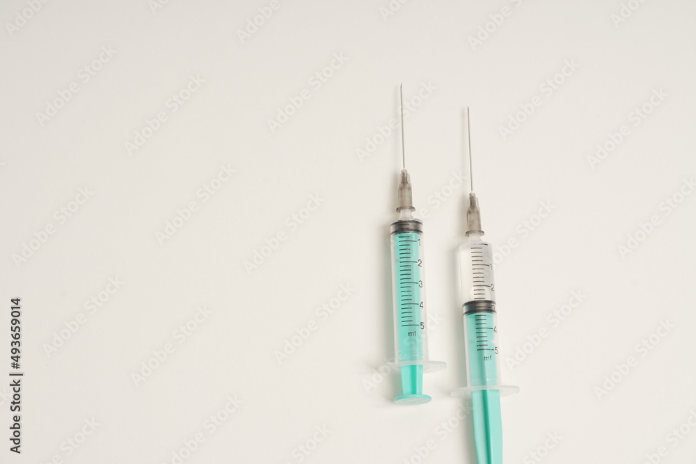 medical disposable syringe with needle for injection in the hospital. medical devices on a white background. virus protection concept medical disposable syringe with needle for injection in the hospital. medical devices on a white background. virus protection concept