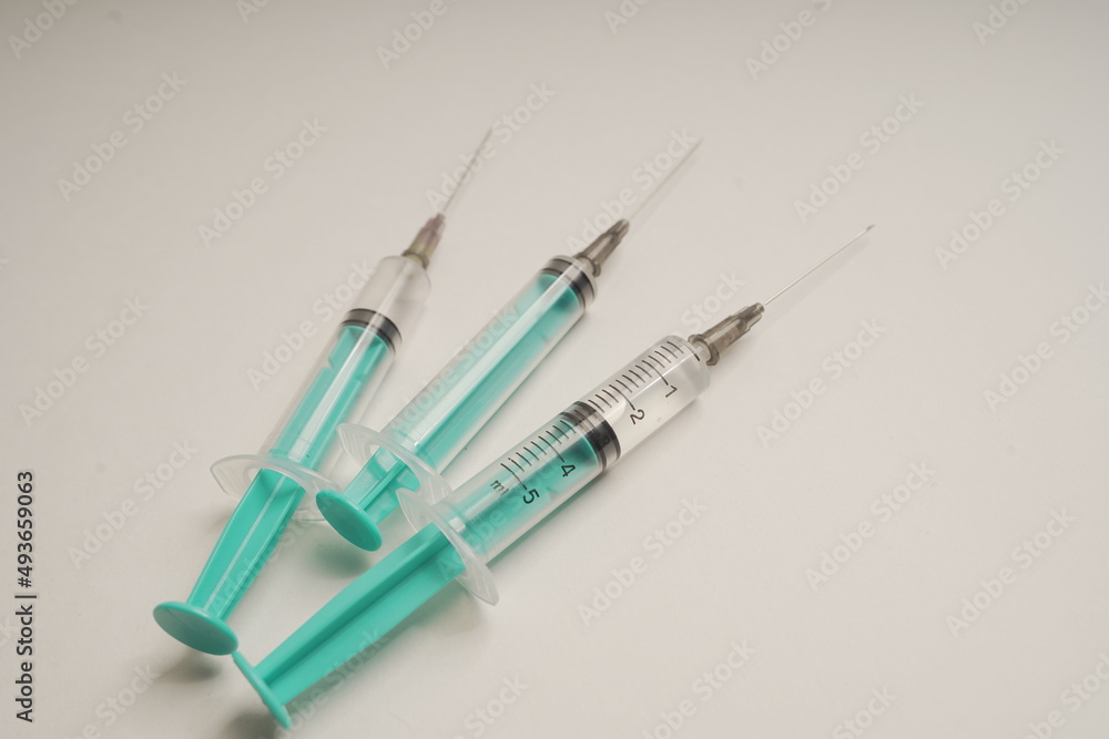 medical disposable syringe with needle for injection in the hospital. medical devices on a white background. virus protection concept medical disposable syringe with needle for injection in the hospital. medical devices on a white background. virus protection concept