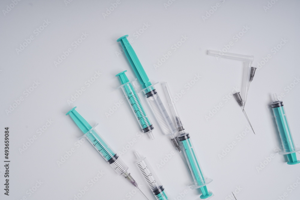 medical disposable syringe with needle for injection in the hospital. medical devices on a white background. virus protection concept medical disposable syringe with needle for injection in the hospital. medical devices on a white background. virus protection concept
