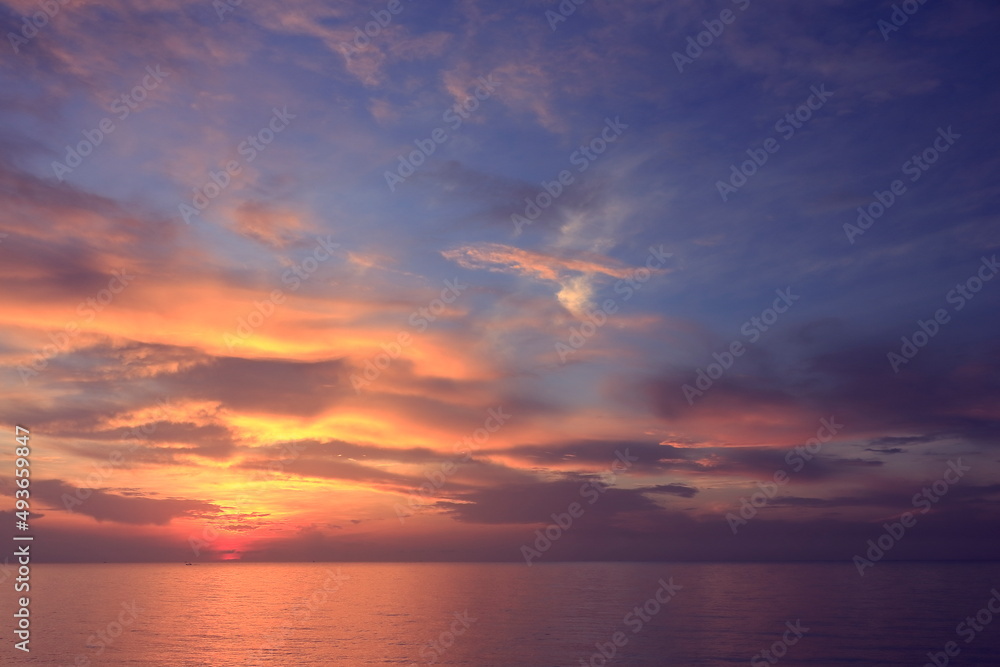 Morning sunrise from the sea in gray clouds Morning sunrise from the sea in gray clouds