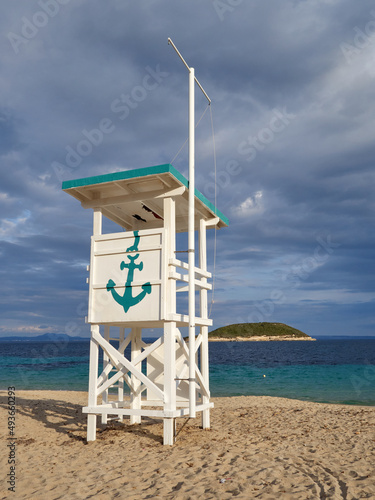 Idyllic scene of Magaluf beach with a white wooden lifeguard stand that has a green anchor painted. Mediterranean sea in Majorca, Balearic Islands, Spain photo