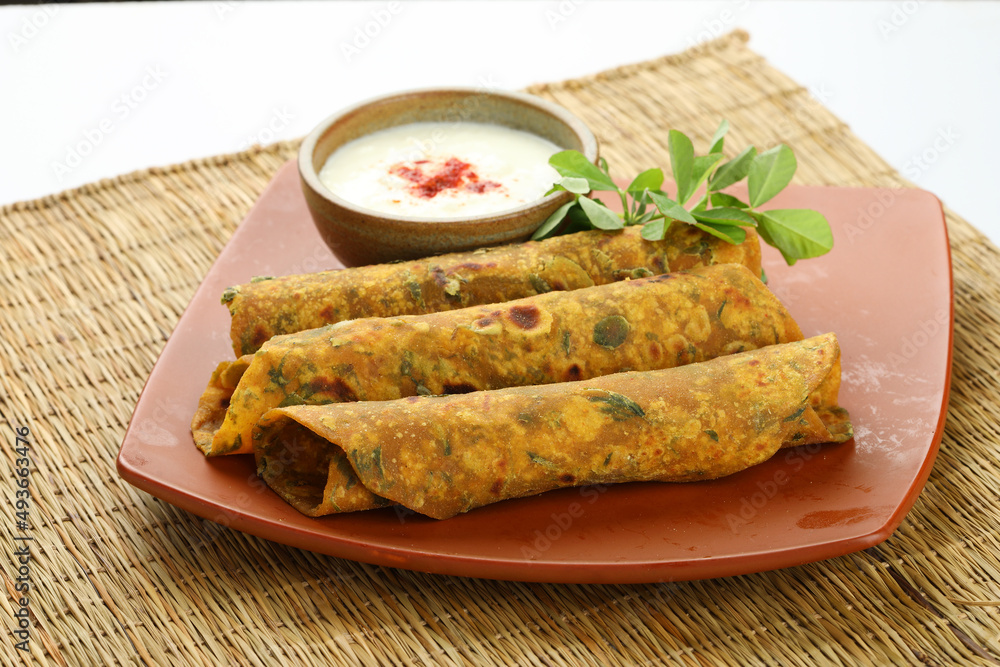 Indian flat bread,Methi Paratha,an Indian flatbread stuffed with fenugreek leaves and spices served with yogurt in breakfast or brunch 