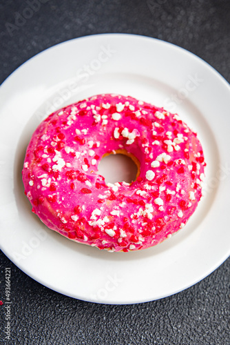 donut pink icing sweet dessert fresh portion healthy meal food diet snack on the table copy space food background rustic top view