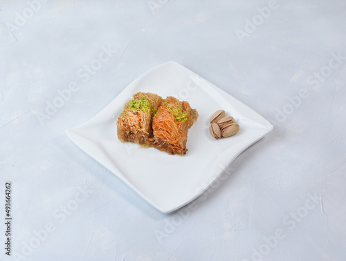 Traditional arabic and turkish sweets pastry dessert kadaif with pistachio.  photo