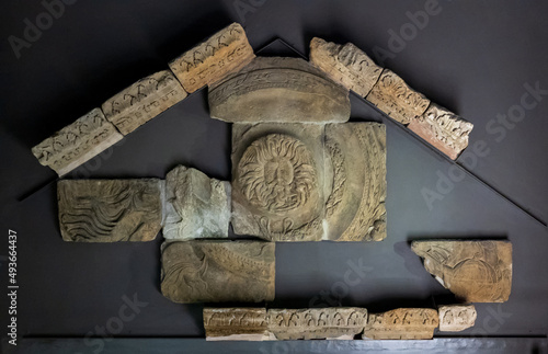 City of Bath, UK. Remains of pediment sculptures from the front entrance to Temple Of Sulis Minerva with the famous Gorgon's Head in Roman Baths. photo