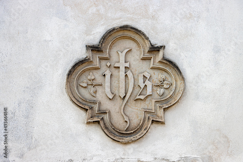 A monogram of the name of Jesus Christ on a facade of the church. photo