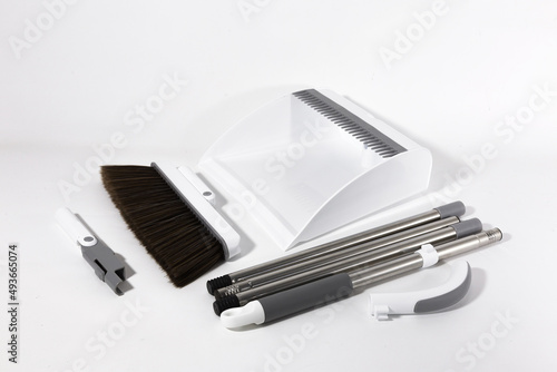 Combined White Set Broom and Scoop. Long handle and soft brush. Durable Plastic. Stainless steel. Housing. Scoop. Brush. Telescopic tubes. White background.