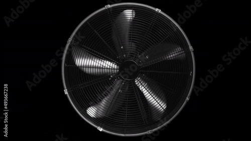 Fan turbine behind a dark surface. Electric fan produce a current of air by slow movement of blades.