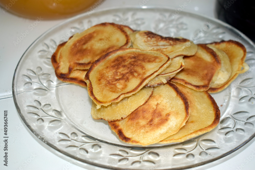 Fried pancakes in a glass transparent plate.