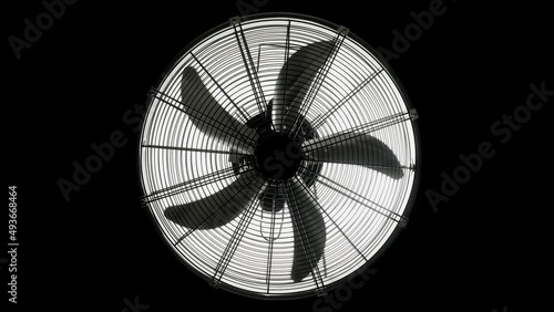 Fan turbine behind a dark surface. Electric fan produce a current of air by slow movement of blades. photo